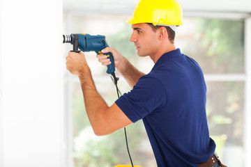 builder drilling wall