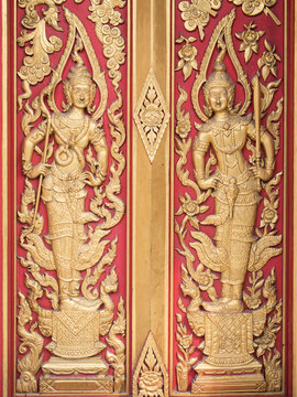 Native Thai style carving, painting on church door in the temple