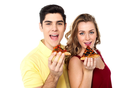 Couple Posing With Pizza Slice, About To Eat