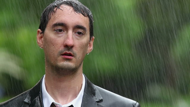 Man wearing suit standing in rain