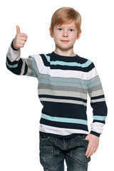 Red-haired boy holds his thumb up