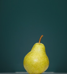 One Pear on Green Background