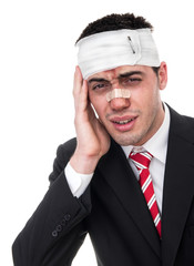 Sad injured business man, isolated on white