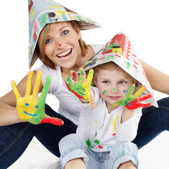 Mother and her son have a lot of fun to paint with colours