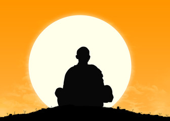 monk in meditation at sunrise
