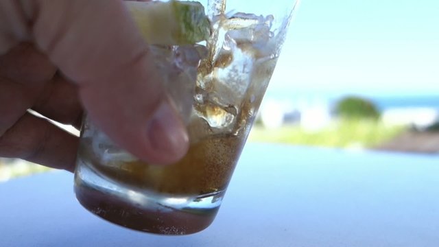Pouring Cola in Glass with Lemon