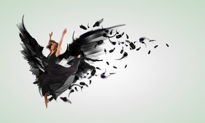 Woman floating   on dark wings