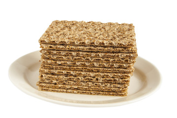 Sesame wholegrain crispbreads on porcelain plate