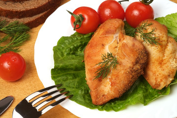 Fried chicken on a background of green lettuce