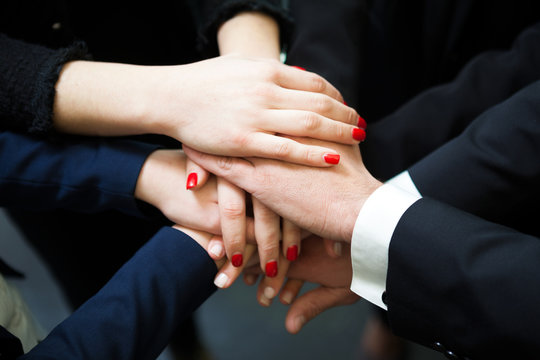 Closeup of pile of hands of business partners