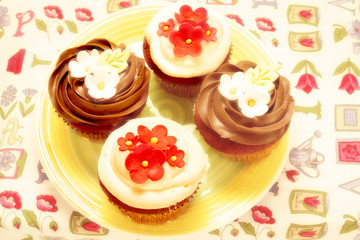 Obraz na płótnie Canvas four delicious cupcakes decorated