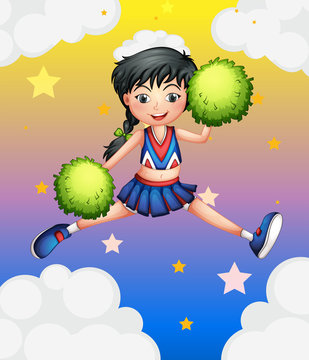 A cheerleader jumping with her green pompoms