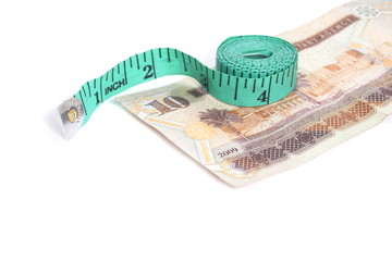 Riyal and tape measure - Arabic Money on white
