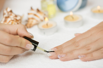 Obraz na płótnie Canvas Manicure treatment - applying cuticle oil