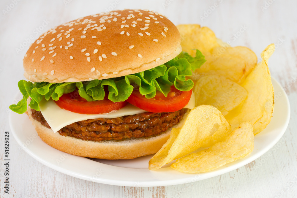 Wall mural cheeseburger with chips on the plate