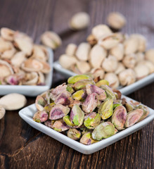 Pistachios in a bowl (on wood)