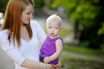 Eight months old baby in mothers hands