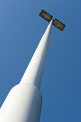 Lamppost at parking of gasstation on highway in closeup