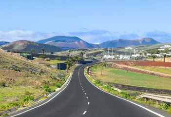 Gordijnen driving in Lanzarote with view to Timanfaya volcanoes © travelview