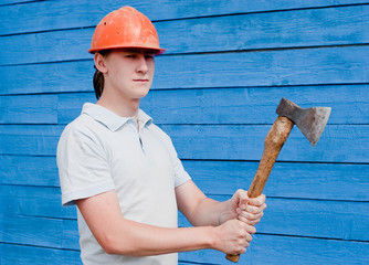 man with axe on blue wooden background