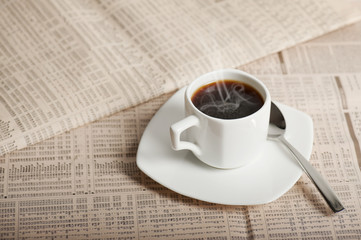coffee cup on newspapers