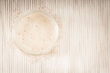 Sourdough in a glass jar with a doily (top view) - 51332661