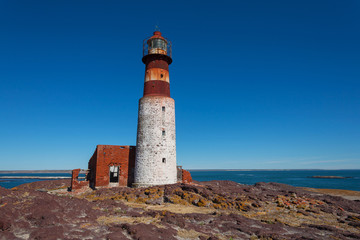 Fototapeta na wymiar Old lighthouse on Penguin island, Puerto Deseado, Argent