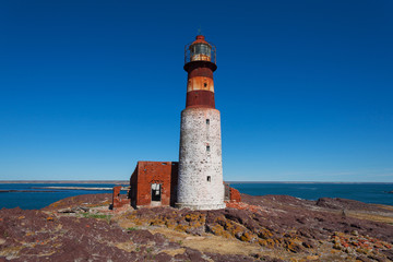 Fototapeta na wymiar Old lighthouse on Penguin island, Puerto Deseado, Argent
