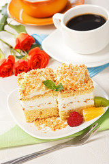 Top view of whipped cream cake garnished with fruit pieces