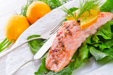 grilled salmon fillets on spinach