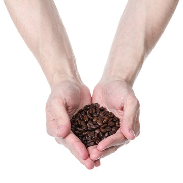 adult man hand holding coffee beans
