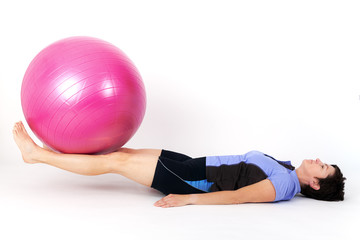 Fototapeta na wymiar Sporty woman doing exercise with gym ball