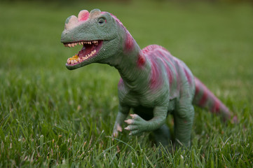 dinosaur toy on grass