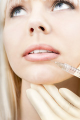Woman having lip augmentation.