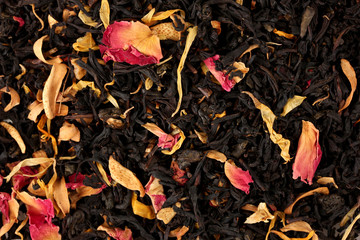 aromatic black dry tea with fruits and petals, close up