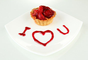 Sweet cake with strawberry and sauce on plate, isolated on