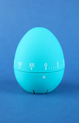 Blue egg timer, on color background
