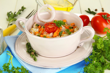 Delicious rice with vegetables and herbs in pot