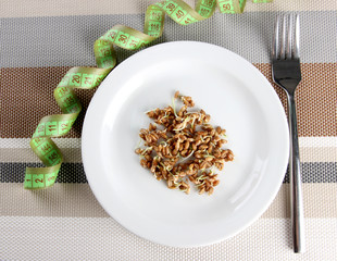 Wheat germs on plate and measuring tape, close up