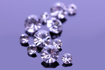 Beautiful shining crystals (diamonds), on purple background