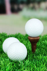 Golf balls on grass outdoor close up