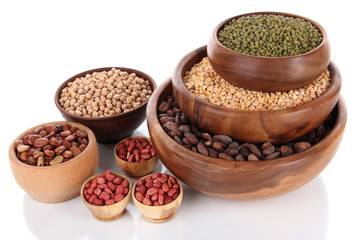 Different kinds of beans in bowls isolated on white