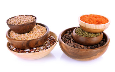 Different kinds of beans in bowls isolated on white