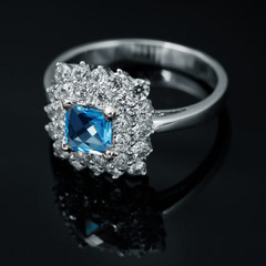 Golden jewelry ring with sapphire and brilliants
