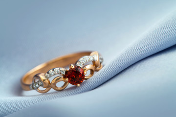 Ring with ruby on grey background - 51349444