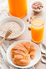 healthy breakfast: croissant, porridge and orange juice