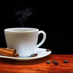 warm cup of coffee on black background