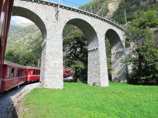 Fototapeta premium red train around the beautiful Swiss mountains 6