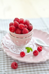 Fresh raspberries in a pink vintage bowl