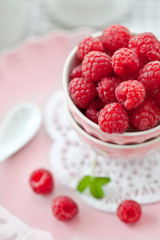 Fresh raspberries in a pink vintage bowl